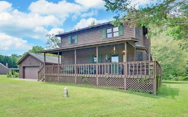 view of front of house with a porch, an outdoor structure, a detached garage, and a front lawn