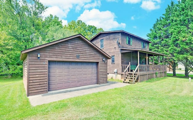 view of front facade featuring an outbuilding, a front yard, a porch, and a garage