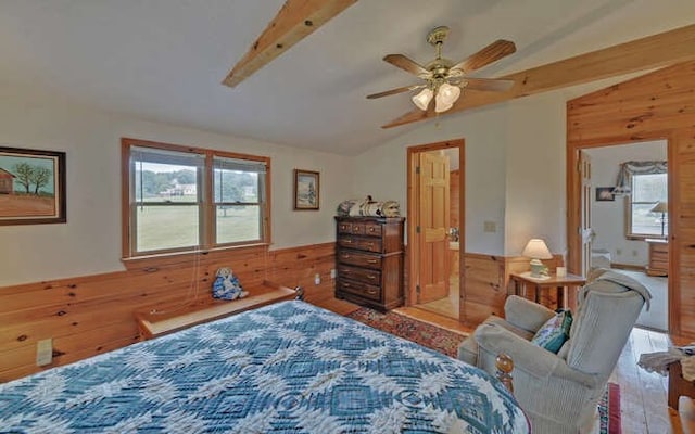 bedroom featuring ceiling fan, wood walls, and vaulted ceiling with beams