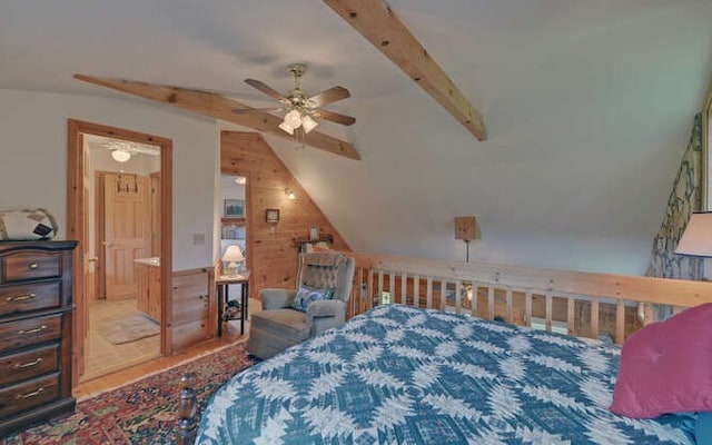 bedroom with ceiling fan, ensuite bath, and lofted ceiling with beams