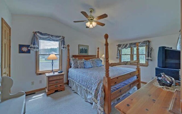 bedroom featuring ceiling fan, lofted ceiling with beams, and wood walls