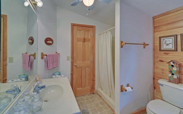 bathroom with toilet, vanity, a shower with curtain, and vaulted ceiling