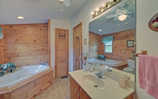 bathroom featuring toilet, wooden walls, lofted ceiling, a washtub, and vanity