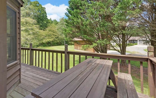 wooden terrace featuring a yard