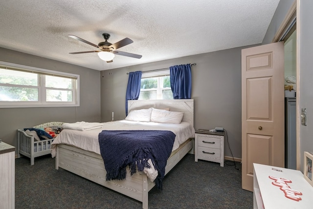 bedroom featuring a textured ceiling, ceiling fan, and dark carpet