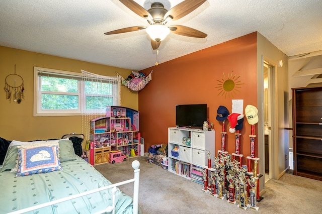 bedroom featuring a ceiling fan, a textured ceiling, and carpet flooring