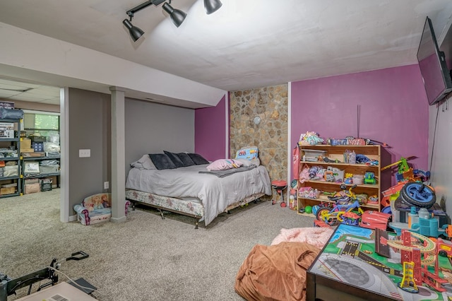 bedroom with rail lighting, a paneled ceiling, and carpet flooring