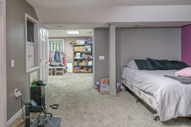 bedroom with baseboards, a paneled ceiling, and carpet