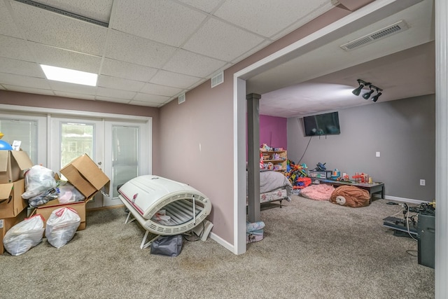 recreation room with a drop ceiling, visible vents, baseboards, and carpet flooring