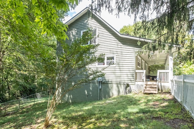 view of side of property featuring a yard and a fenced backyard