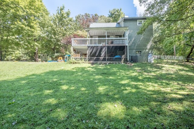 back of property featuring a lawn, a deck, fence, central AC unit, and stairs