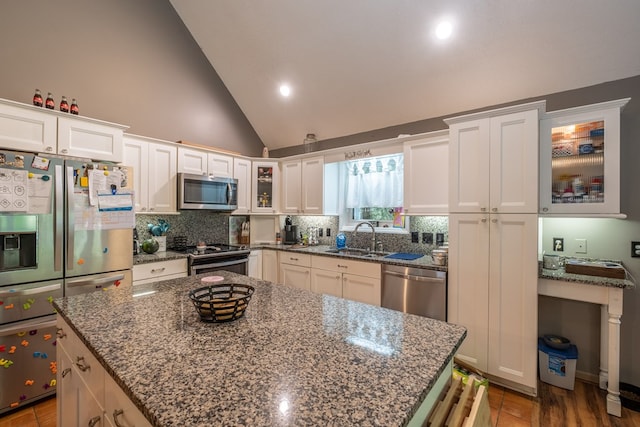 kitchen featuring a sink, decorative backsplash, appliances with stainless steel finishes, and white cabinets