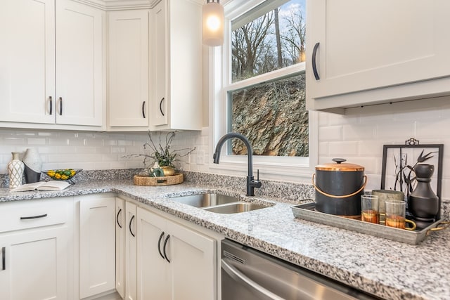 kitchen with a sink, decorative backsplash, and white cabinets