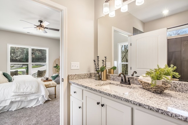 bathroom featuring ensuite bath, vanity, and a ceiling fan