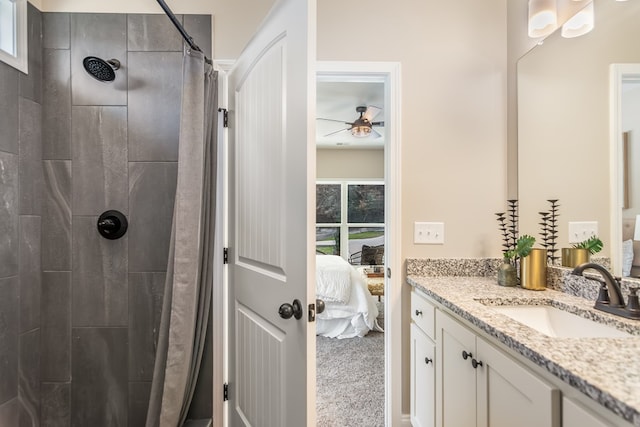 full bath with connected bathroom, tiled shower, and vanity