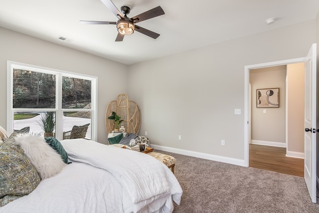 bedroom featuring carpet flooring, visible vents, baseboards, and ceiling fan