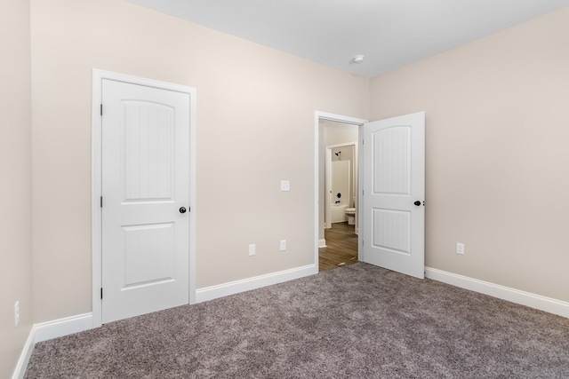 unfurnished bedroom featuring baseboards and carpet