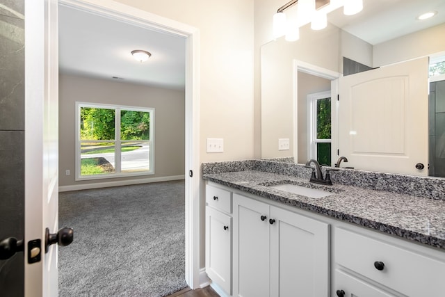 bathroom with vanity and baseboards