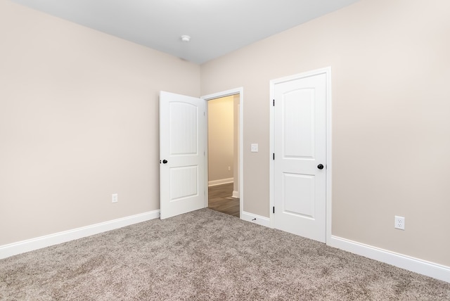 unfurnished bedroom with baseboards and carpet floors