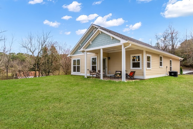 back of house featuring a patio, central AC unit, and a lawn