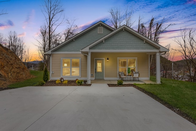 view of front of home with a yard and covered porch