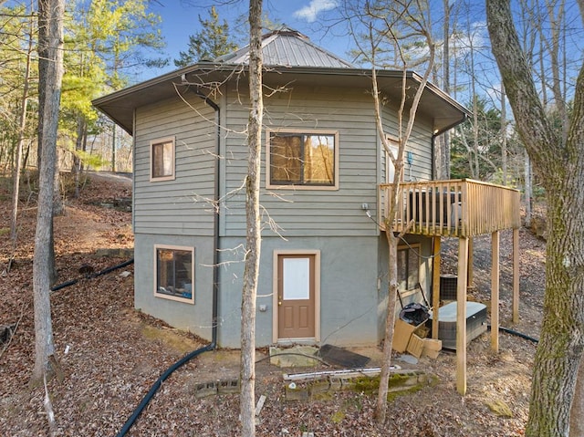 back of house featuring a wooden deck