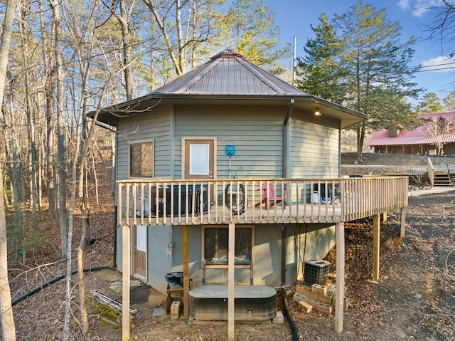 back of property featuring central AC and a wooden deck