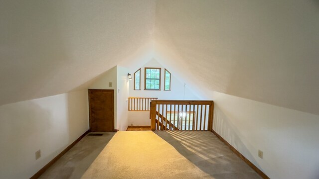 bonus room featuring carpet floors and lofted ceiling