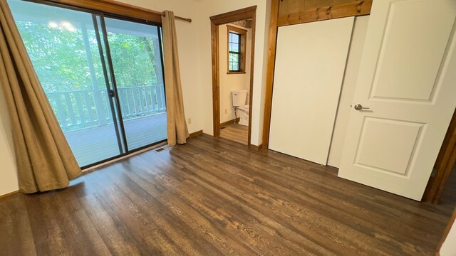 interior space featuring dark wood-type flooring and access to exterior