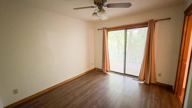 empty room featuring dark hardwood / wood-style flooring and ceiling fan