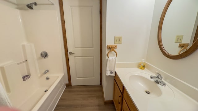 bathroom featuring shower / washtub combination, hardwood / wood-style flooring, and vanity