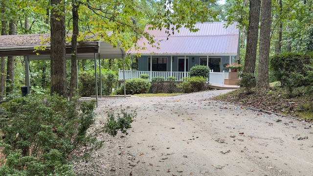 rear view of property featuring covered porch