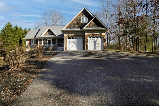 view of front of property with a porch and a garage