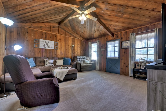 carpeted living room with wood ceiling, ceiling fan, wooden walls, and lofted ceiling with beams