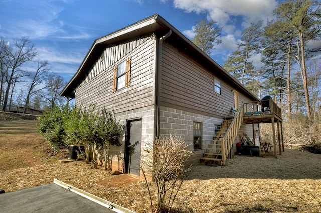 view of home's exterior featuring a wooden deck