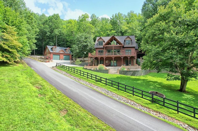 view of front of house with fence, a front lawn, and an outdoor structure