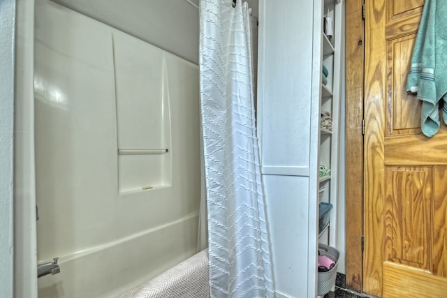 bathroom with shower / bath combo with shower curtain