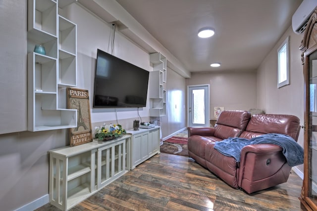 living room with a wall mounted air conditioner and dark wood-type flooring