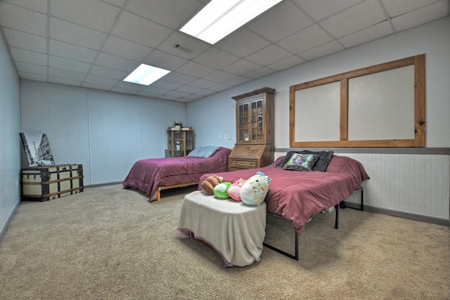 carpeted bedroom featuring a paneled ceiling