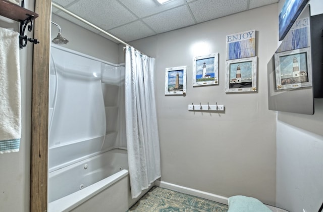 bathroom featuring shower / bath combination with curtain and a drop ceiling