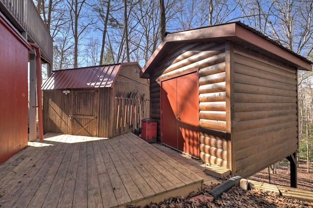 wooden terrace with a storage shed