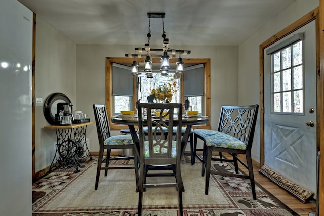 dining room with hardwood / wood-style flooring and a notable chandelier