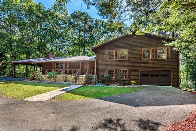 tri-level home featuring a porch, a garage, and a front lawn