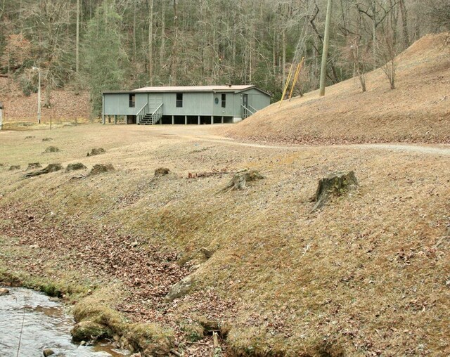 view of front of property featuring stairway