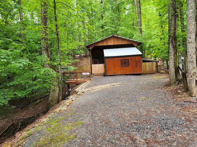garage featuring a view of trees