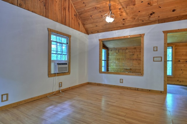 unfurnished room featuring wood finished floors, lofted ceiling, baseboards, wooden ceiling, and cooling unit