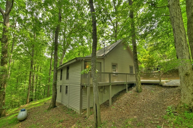 view of property exterior with a deck