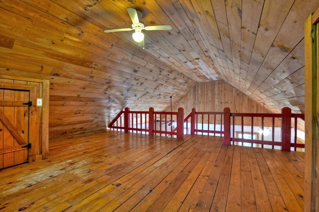 additional living space with ceiling fan, wood-type flooring, wooden ceiling, and vaulted ceiling