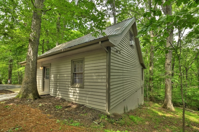view of property exterior featuring metal roof