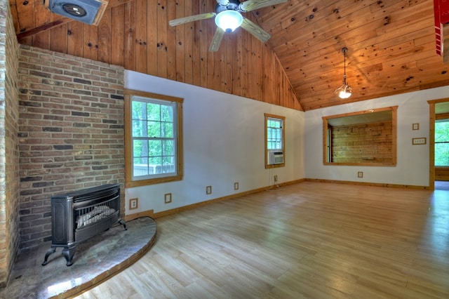 unfurnished living room featuring a wood stove, high vaulted ceiling, wood ceiling, heating unit, and wood finished floors